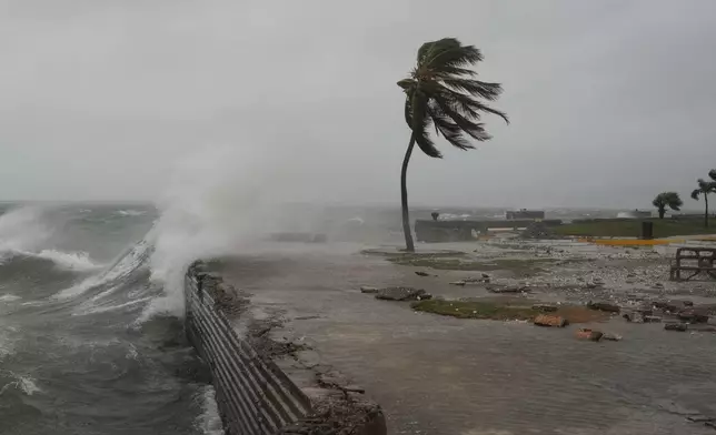Waves splash in Kingston, Jamaica, as Hurricane Melissa approaches, Tuesday, Oct. 28, 2025. (AP Photo/Matias Delacroix)