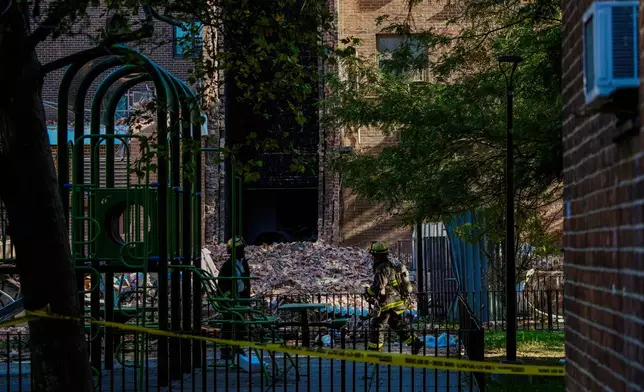 Firefighters work near the site of a building collapse in the Bronx borough of New York, Wednesday, Oct. 1, 2025. (AP Photo/Eduardo Munoz Alvarez)