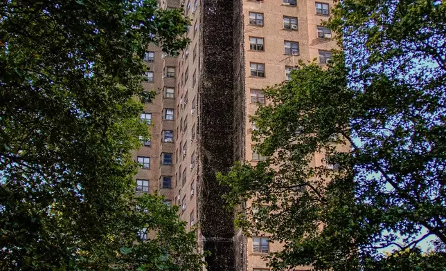 Firefighters work near the site of a building collapse in the Bronx borough of New York, Wednesday, Oct. 1, 2025. (AP Photo/Eduardo Munoz Alvarez)