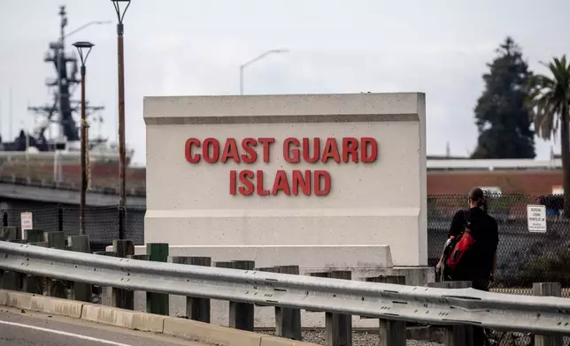 A sign stands by the bridge that leads to Coast Guard Island Alameda in Oakland, Calif., Wednesday, Oct. 22, 2025. (Stephen Lam/San Francisco Chronicle via AP)