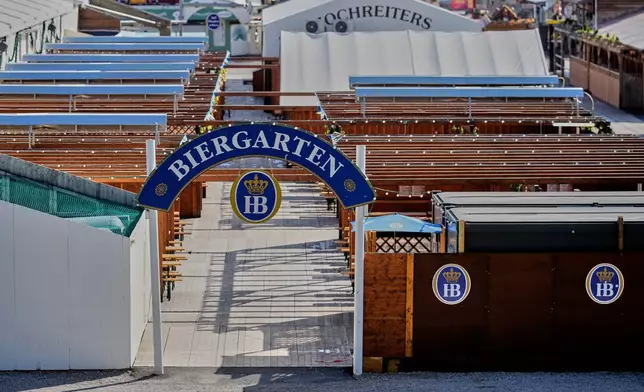 An empty Biergarten at he Oktoberfest area that stays closed after a bomb threatening in Munich, Germany, Wednesday, Oct.1, 2025. (AP Photo/Matthias Schrader)