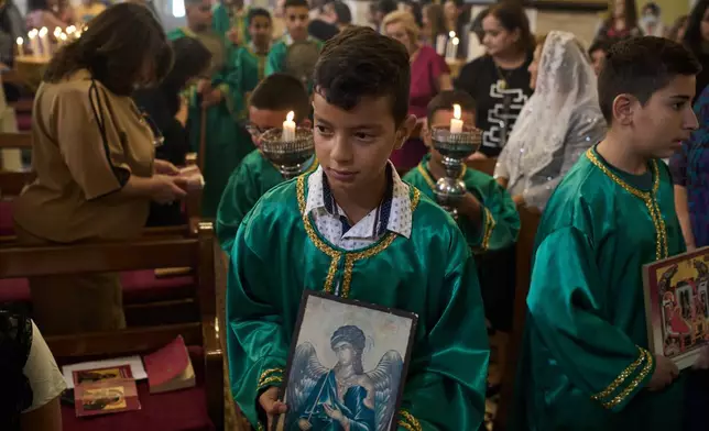 Palestinian children attend morning Mass at the Greek Orthodox Church of St. George in the West Bank village of Taybeh, Sept. 28, 2025. (AP Photo/Leo Correa)