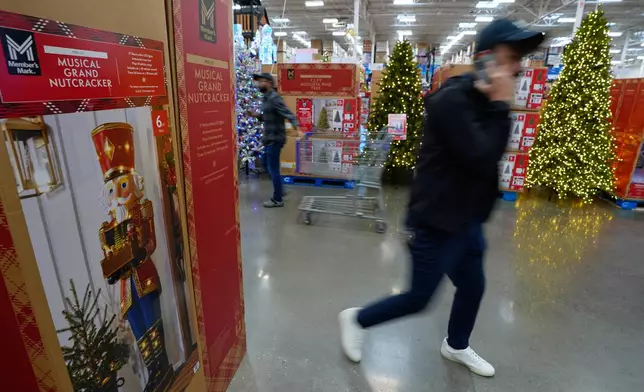 People shop among holiday displays at a Sam's Club, Wednesday, Sept. 24, 2025, in Bentonville, Ark. (AP Photo/Charlie Riedel)