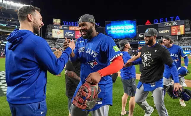 Toronto Blue Jays first baseman Vladimir Guerrero Jr. celebrates with teammates after beating the New York Yankees in Game 4 of baseball's American League Division Series, Wednesday, Oct. 8, 2025, in New York. (AP Photo/Frank Franklin II)