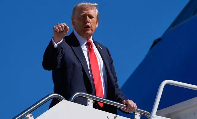 President Donald Trump gestures as he boards Air Force One, Sunday, Oct. 5, 2025, at Joint Base Andrews, Md., en route to Norfolk, Va. (AP Photo/Alex Brandon)