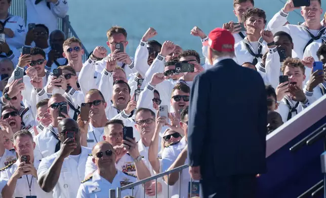 President Donald Trump arrives to speak during a celebration for the 250th anniversary of the U.S. Navy aboard the USS Harry S. Truman at Naval Station Norfolk, Sunday Oct. 5, 2025 in Norfolk, Va. (AP Photo/Steve Helber)