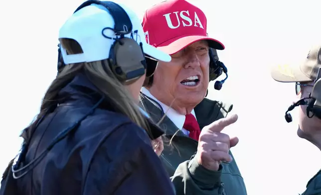 President Donald Trump and first lady Melania Trump watch a naval sea power demonstration, part of the Navy's 250th anniversary celebration, aboard the USS George H.W. Bush aircraft carrier in the Atlantic Ocean off the coast of Norfolk, Va., Sunday, Oct. 5, 2025. (AP Photo/Alex Brandon)