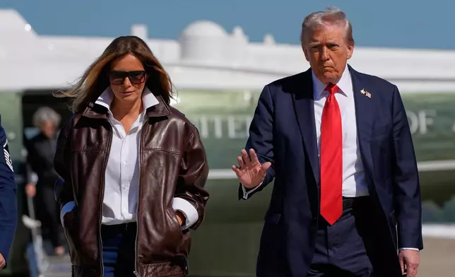 President Donald Trump and first lady Melania Trump walk from Marine One to board Air Force One, Sunday, Oct. 5, 2025, at Joint Base Andrews, Md., en route to Norfolk, Va. (AP Photo/Alex Brandon)