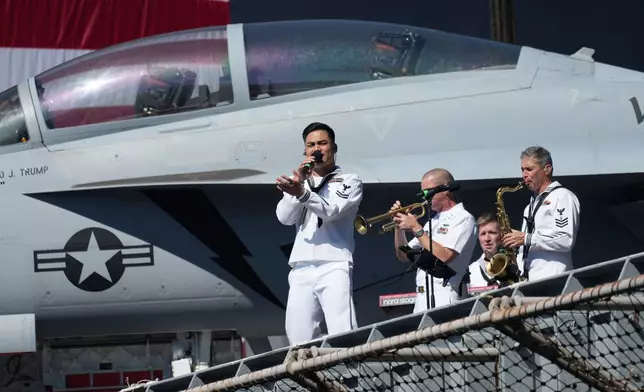 A Navy band performs before President Donald Trump arrives to speak during a celebration for the 250th anniversary of the U.S. Navy aboard the USS Harry S. Truman at Naval Station Norfolk, Sunday Oct. 5, 2025 in Norfolk, Va. (AP Photo/Steve Helber)