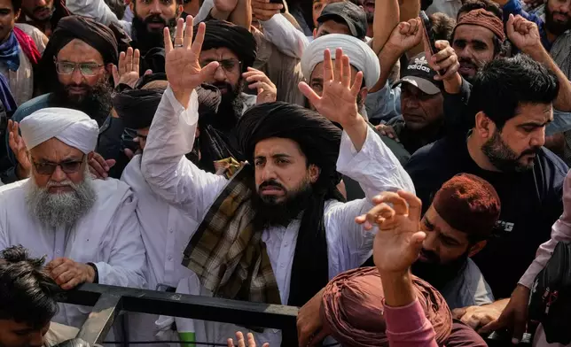 Hafiz Saad Hussain Rizvi, center, head of Islamist party 'Tehreek-e-Labbaik Pakistan' leads a rally to show their solidarity with Palestinian people, in Lahore, Pakistan, Friday, Oct. 10, 2025. (AP Photo/K.M. Chaudary)