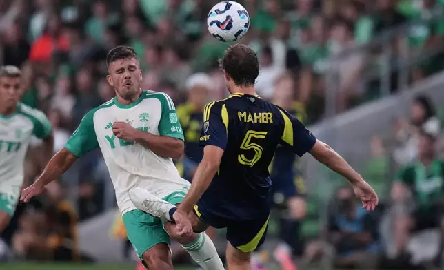 Nashville SC defender Jack Maher (5) kicks the ball and Austin FC forward Diego Rubio (21) during the first half of an U.S. Open Cup final soccer match in Austin, Texas, Wednesday, Oct. 1, 2025. (AP Photo/Eric Gay)