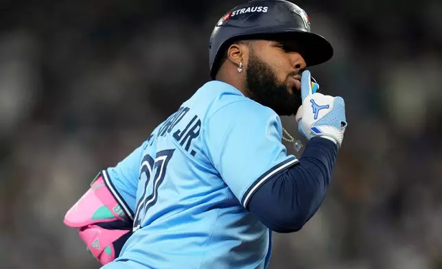Toronto Blue Jays' Vladimir Guerrero Jr. celebrates after hitting a solo home run against the Seattle Mariners during the seventh inning in Game 4 of baseball's American League Championship Series, Thursday, Oct. 16, 2025, in Seattle. (AP Photo/Abbie Parr)