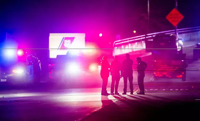 Law enforcement officers investigate the entrance to Coast Guard Base Alameda after shots were fired at a U-Haul truck, according to an officer at the scene, on Friday, Oct. 24, 2025, in Oakland, Calif. (AP Photo/Noah Berger)