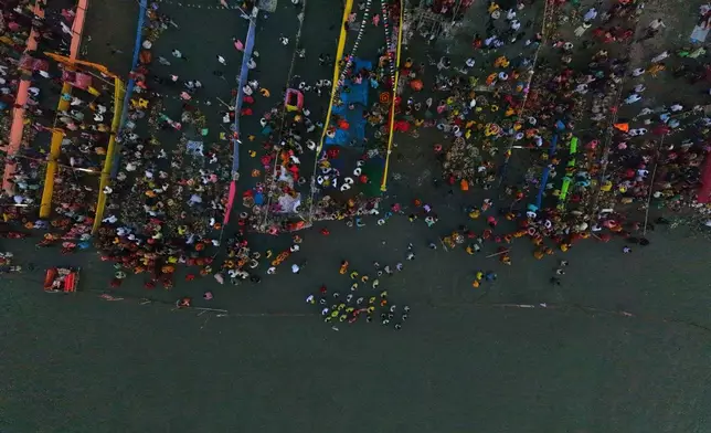 Indian Hindu devotees perform rituals in the the river Brahmaputra during the Chhath Puja festival in Guwahati, India, Monday, Oct. 27, 2025. (AP Photo/Anupam Nath)