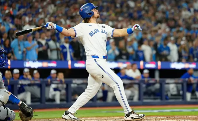 Toronto Blue Jays' Addison Barger watches his grand slam against the Los Angeles Dodgers during the sixth inning of Game 1 of baseball's World Series in Toronto, Friday, Oct. 24, 2025. (Frank Gunn/The Canadian Press via AP)