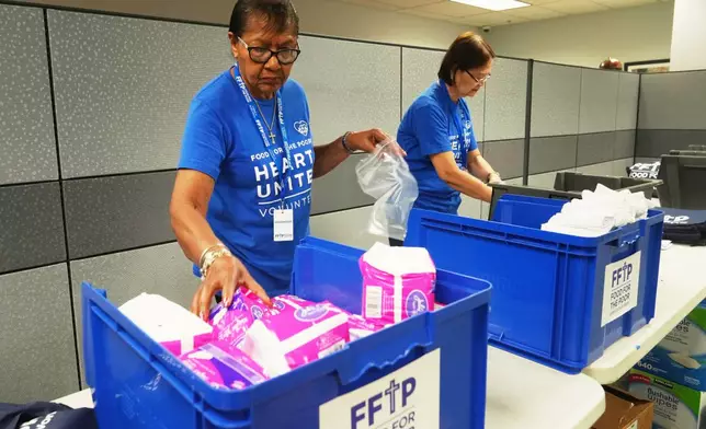 Volunteers put together feminine hygiene packages for those affected by Hurricane Melissa in Jamaica Thursday, Oct. 30, 2025, at Food for the Poor in Coconut Creek, Fla. (AP Photo/Marta Lavandier)