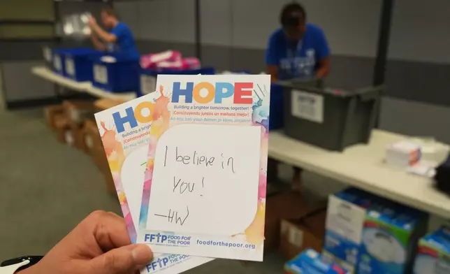 Encouraging notes written by volunteers wait to be placed in feminine hygiene packages bound for Jamaica, Thursday, Oct. 30, 2025, at Food for the Poor in Coconut Creek, Fla. (AP Photo/Marta Lavandier)