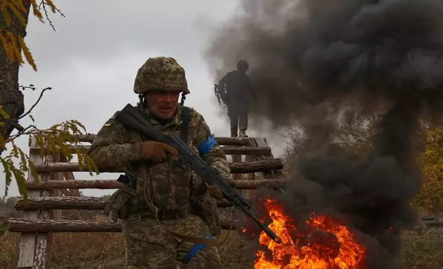 In this photo provided by Ukraine's 65th Mechanized Brigade press service, recruits attend drills at a training ground in the Zaporizhzhia region, Ukraine, Saturday, Oct. 11, 2025. (Andriy Andriyenko/Ukraine's 65th Mechanized Brigade via AP)