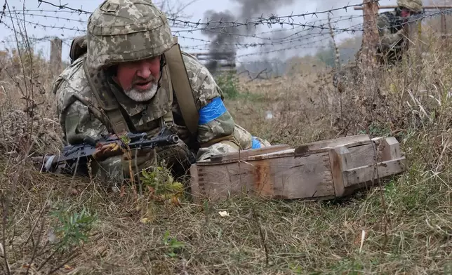 In this photo provided by Ukraine's 65th Mechanized Brigade press service, recruits attend drills at a training ground in the Zaporizhzhia region, Ukraine, Saturday, Oct. 11, 2025. (Andriy Andriyenko/Ukraine's 65th Mechanized Brigade via AP)