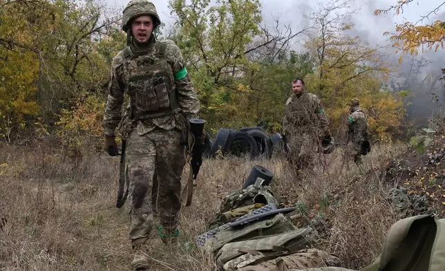 In this photo provided by Ukraine's 65th Mechanized Brigade press service, recruits attend drills at a training ground in the Zaporizhzhia region, Ukraine, Saturday, Oct. 11, 2025. (Andriy Andriyenko/Ukraine's 65th Mechanized Brigade via AP)