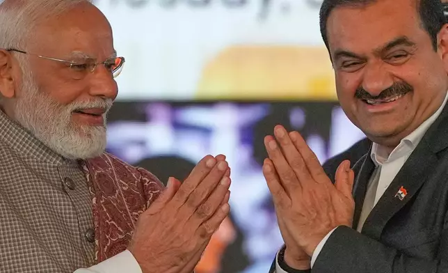 Indian Prime Minister Narendra Modi, left, greets Chairman Adani Group, Gautam Adani during the inauguration ceremony of the Navi Mumbai International Airport in Navi Mumbai, India, Wednesday, Oct. 8, 2025. (AP Photo/Rafiq Maqbool)
