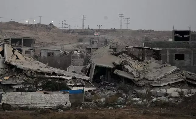 Red Cross vehicles carrying the bodies of two people believed to be deceased hostages handed over by Hamas make their way toward the Kissufim border crossing with Israel, to be transferred to Israeli authorities, in Deir al-Balah, central Gaza Strip, Thursday, Oct. 30, 2025. (AP Photo/Abdel Kareem Hana)