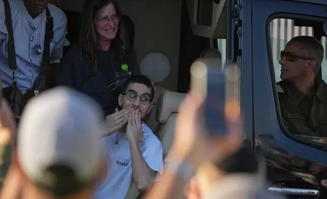 Freed Israeli hostage Evyatar David gestures from a van as he arrives at Beilinson hospital in Petah Tikva, Israel, after he was released from Hamas captivity in the Gaza Stripl, Monday, Oct. 13, 2025. (AP Photo/Ariel Schalit)