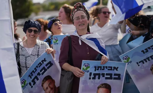 People react as they wait outside Beilinson Hospital in Petah Tikva, Israel, where some of the freed hostages are expected to arrive after being released from Hamas captivity in the Gaza Strip, Monday, Oct. 13, 2025. (AP Photo/Francisco Seco)