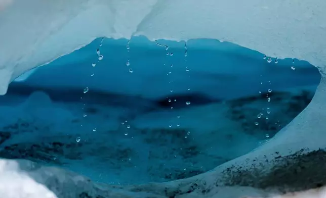 FILE - Water drips from a melting chunk of ice that originated from the Rhone Glacier near Goms, Switzerland, on June 10, 2025. (AP Photo/Matthias Schrader, File)