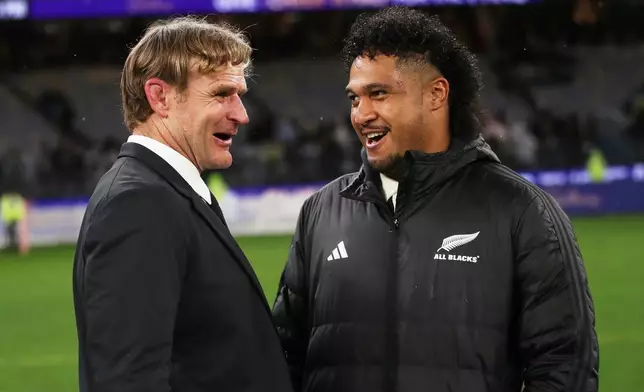 New Zealand coach Scott Robertson, left, talks to Leicester Fainga'anuku following the Bledisloe Cup rugby test between the All Blacks and the Wallabies in Perth, Australia, Saturday, Oct 4, 2025. (AP Photo/Gary Day)