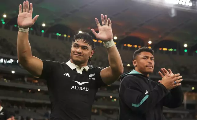 New Zealand's Wallace Sititi, left, and teammate Caleb Clarke wave to fans following the Bledisloe Cup rugby test between the All Blacks and the Wallabies in Perth, Australia, Saturday, Oct 4, 2025. (AP Photo/Gary Day)