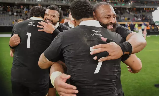 New Zealand's George Bower, right, embraces teammate Ardie Savea following the Bledisloe Cup rugby test between the All Blacks and the Wallabies in Perth, Australia, Saturday, Oct 4, 2025. (AP Photo/Gary Day)