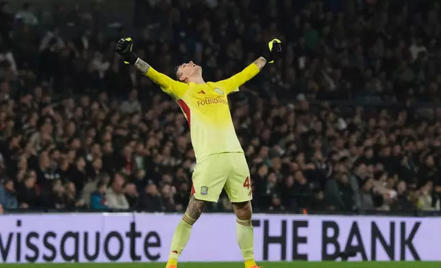 Aston Villa's goalkeeper Marco Bizot celebrates his side's opening goal scored by Emiliano Buendia during the Europa League opening phase soccer match between Feyenoord and Aston Villa at the Feyenoord "De Kuip" stadium in Rotterdam, Netherlands, Thursday, Oct. 2, 2025. (AP Photo/Patrick Post)