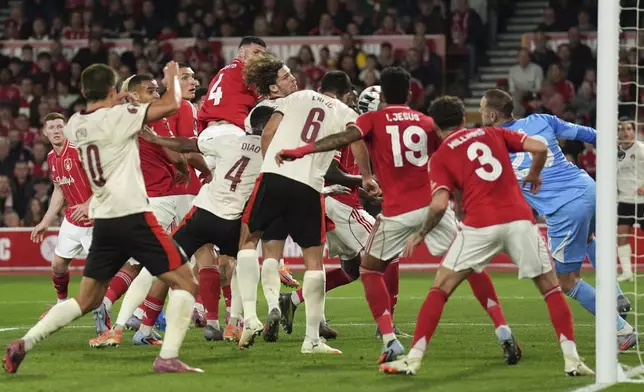 Midtjylland's Mads Sorensen, center, scores during the Europa League soccer match between Nottingham Forest and Midtjylland at the City Ground, Nottingham, England, Thursday Oct. 2, 2025. (Joe Giddens/PA via AP)