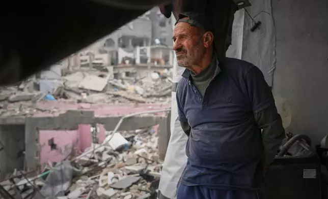 Khaled Nassar looks over the destruction at his apartment in the Jabaliya refugee camp in Gaza City Feb. 9, 2025. Nassar's daughter, Dalia, and his son, Mahmoud, were killed in separate airstrikes, leaving both buried under their homes. (AP Photo/Abdel Kareem Hana)