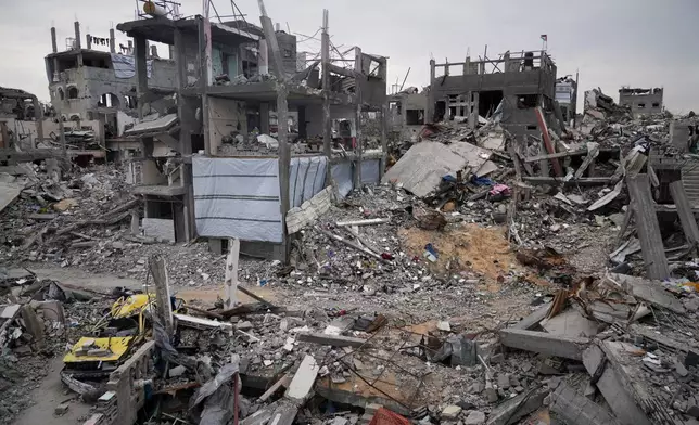 Ruins of apartments destroyed by Israeli strikes litter the area next to Khaled Nassar's home in the Jabaliya refugee camp in Gaza City Feb. 9, 2025. Nassar's daughter, Dalia, and his son, Mahmoud, were killed in separate airstrikes, leaving both buried under their homes. (AP Photo/Abdel Hana)