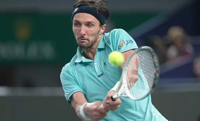 Arthur Rinderknech of France hits a return to Valentin Vacherot of Monaco during the final of the Shanghai Masters tennis tournament at Qizhong Forest Sports City Tennis Center, in Shanghai, China, Sunday, Oct. 12, 2025. (AP Photo/Andy Wong)