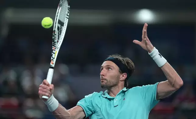 Arthur Rinderknech of France hits a return to Valentin Vacherot of Monaco during the final of the Shanghai Masters tennis tournament at Qizhong Forest Sports City Tennis Center, in Shanghai, China, Sunday, Oct. 12, 2025. (AP Photo/Andy Wong)