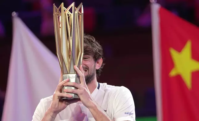 Valentin Vacherot of Monaco celebrates with the trophy after winning the final of the Shanghai Masters tennis tournament defeating Arthur Rinderknech of France at Qizhong Forest Sports City Tennis Center, in Shanghai, China, Sunday, Oct. 12, 2025. (AP Photo/Andy Wong)