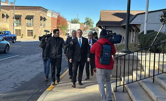 Former Spartanburg County Sheriff Chuck Wright is asked a question as he walks into a federal courthouse to plead guilty in Anderson, S.C., Thursday, Oct. 30, 2025. (AP Photo/Jeffrey Collins)