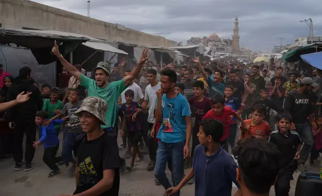 Palestinians celebrate following the announcement that Israel and Hamas have agreed to the first phase of a peace plan to pause the fighting, in Khan Younis, southern Gaza Strip, Thursday, Oct. 9, 2025. (AP Photo/Jehad Alshrafi)
