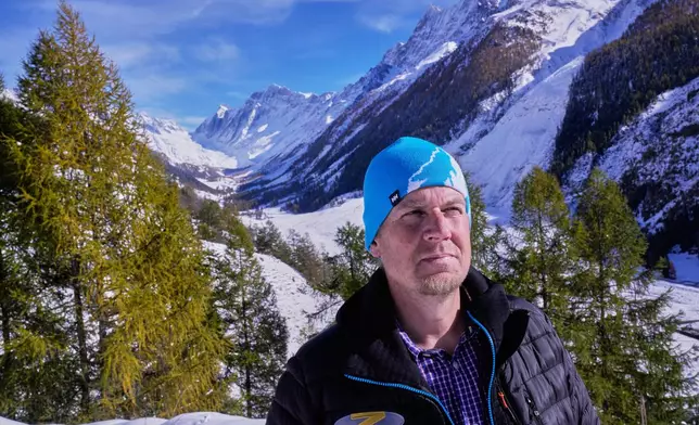 Manfred Ebener talks to media near village of Blatten after recent snowfalls, five months after a landslide destroyed the village, Blatten, Switzerland, on Tuesday, Oct. 28, 2025. (AP Photo/Michael Probst)