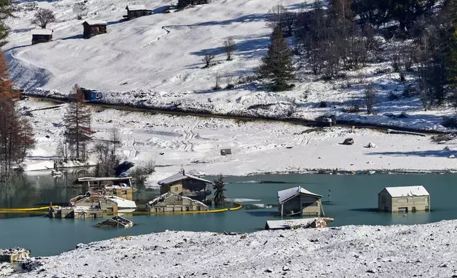Picture shows the partly flooded village of Blatten after recent snowfalls, five months after a landslide destroyed the village, Blatten, Switzerland, on Tuesday, Oct. 28, 2025. (AP Photo/Michael Probst)