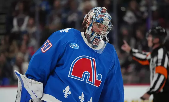 Colorado Avalanche goaltender Trent Miner returns to the net after a time out against the Carolina Hurricanes in the second period of an NHL hockey game Thursday, Oct. 23, 2025, in Denver. (AP Photo/David Zalubowski)