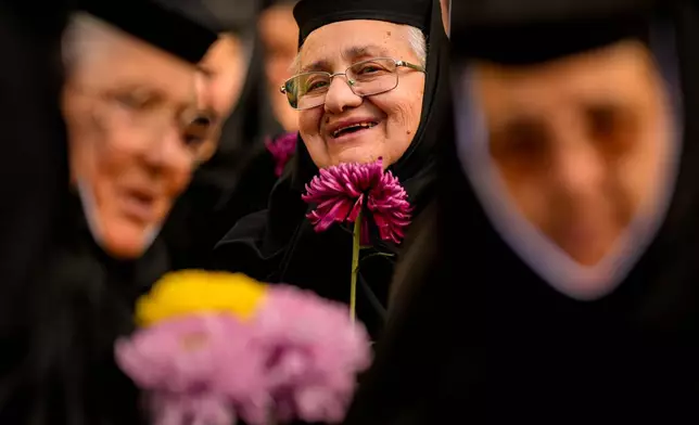 Orthodox nuns attend the procession of Saint Dimitrie Bassarabov, the patron saint of the Romanian capital, in Bucharest, Romania, Thursday, Oct. 23, 2025. (AP Photo/ Vadim Ghirda)