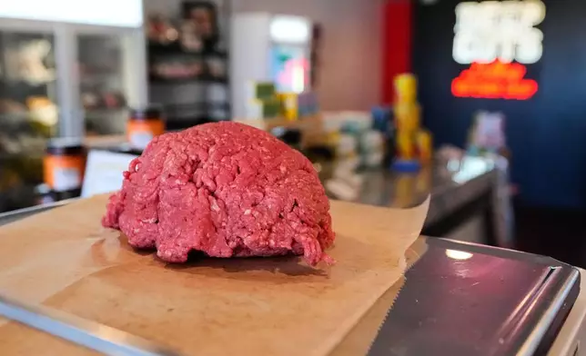 An order of ground beef is prepared for a customer at Deep Cuts butcher shop, Tuesday, Oct. 21, 2025, in Dallas. (AP Photo/Tony Gutierrez)