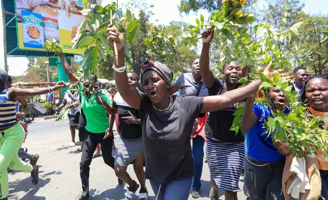 People react in the Kibera neighborhood of Nairobi, Kenya, to the death of Kenya former prime minister Raila Odinga Wednesday, Oct. 15, 2025. Odinga died of a heart attack in Indiaat the age of 80. (AP Photo/Andrew Kasuku)