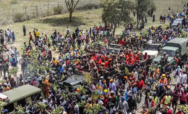 Mourners gather for the arrival of the body of Kenya's former Prime Minister Raila Odinga arrives in Nairobi, Kenya, a day after he died in India, Thursday, Oct. 16, 2025. (AP Photo/Samson Otieno)
