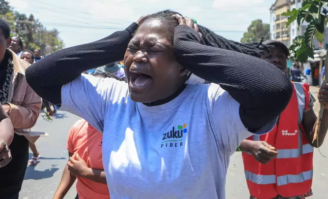 People react in the Kibera neighborhood of Nairobi, Kenya, to the death of Kenya former prime minister Raila Odinga Wednesday, Oct. 15, 2025. Odinga died of a heart attack in Indiaat the age of 80. (AP Photo/Andrew Kasuku)
