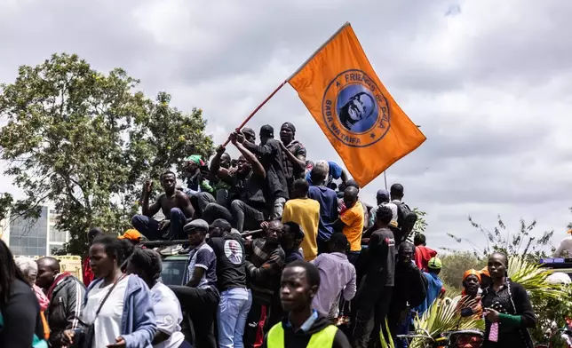 Mourners gather for the arrival of the body of Kenya's former Prime Minister Raila Odinga arrives in Nairobi, Kenya, a day after he died in India, Thursday, Oct. 16, 2025. (AP Photo/Samson Otieno)